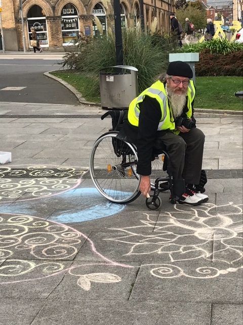 John Baldwin creating flower inspired street art at the Culture Strategy launch in Barnstaple